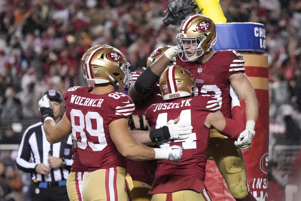 SANTA CLARA, CALIFORNIA - JANUARY 20: Christian McCaffrey #23 of the San Francisco 49ers celebrates with teammates after scoring a 6-yard rushing touchdown during the fourth quarter against the Green Bay Packers in the NFC Divisional Playoffs at Levi's Stadium on January 20, 2024 in Santa Clara, California. (Photo by Thearon W. Henderson/Getty Images)