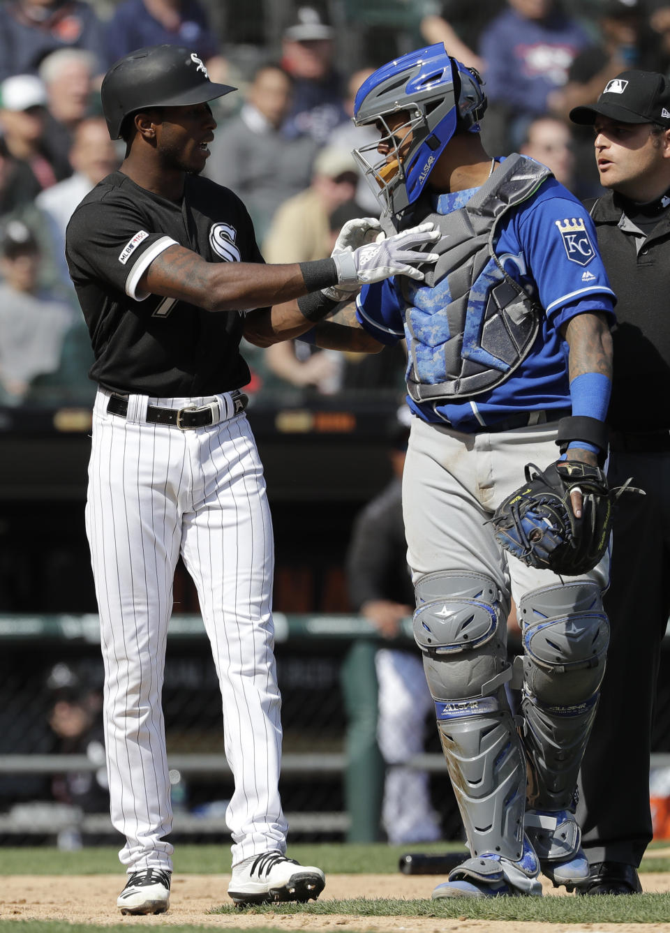 Chicago White Sox's Tim Anderson, left, talks to Kansas City Royals catcher Martin Maldonado after being hit by a pitch during the sixth inning of a baseball game in Chicago, Wednesday, April 17, 2019. (AP Photo/Nam Y. Huh)