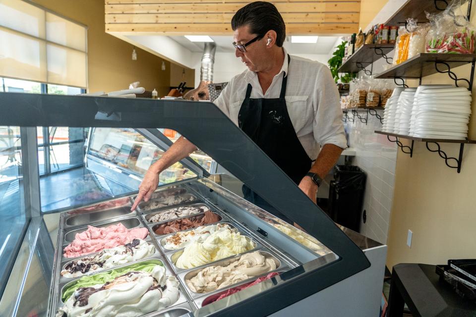 Chef Fabio Ceschetti, chef and owner at Fabio on Fire Panini and Gelateria, displays a variety of gelati inside the restaurant in Peoria on June 13, 2023.