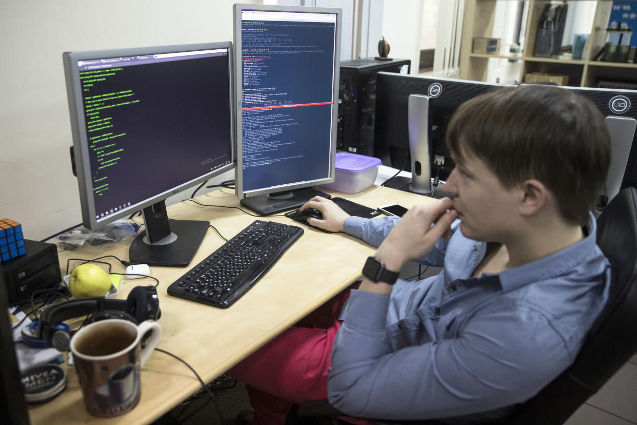 An employee of Global Cyber Security Company Group-IB develops a computer code in an office in Moscow, Russia, Wednesday, Oct. 25, 2017. A new strain of malicious software has paralyzed computers at a Ukrainian airport, the Ukrainian capital's subway and at some independent Russian media. Moscow-based Global Cyber Security Company Group-IB said in a statement Wednesday the ransomware called BadRabbit also tried to penetrate the computers of major Russian banks but failed. None of the banks has reported any attacks. (AP Photo/Pavel Golovkin)