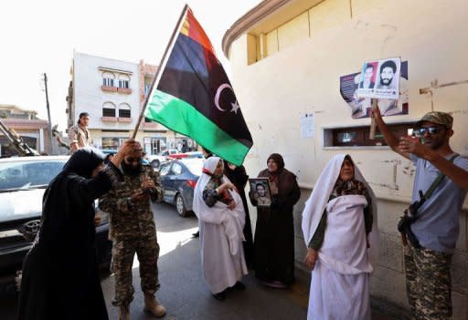 Relatives of victims of the Abu Salim prison 1996 massacre hold portraits of their loved ones as they celebrate following extradition of Abdullah al-Senussi, fallen dictator Moamer Kadhafi's former spy chief, to Libya by Mauritania. Senussi could be held accountable for the Abu Salim prison massacre when more than 1,000 detainees were executed