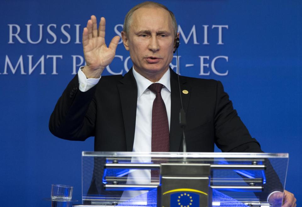 Russian President Vladimir Putin gestures while speaking during a news conference at the European Commission headquarters in Brussels, Belgium, Tuesday, Jan. 28, 2014. Russian President Vladimir Putin and European Union leaders are looking for meager common ground during what promises to be a difficult summit centering on Ukraine and human rights. (AP Photo/Alexander Zemlianichenko)