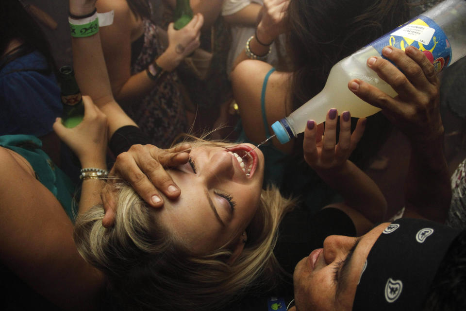 In this March 7, 2012 photo, a woman drinks at a bar during Spring Break in Cancun, Mexico. While American tourism to Mexico slipped a few percentage points last year, the country remains by far the biggest tourist destination for Americans, according to annual survey of bookings by the largest travel agencies. (AP Photo/Israel Leal)