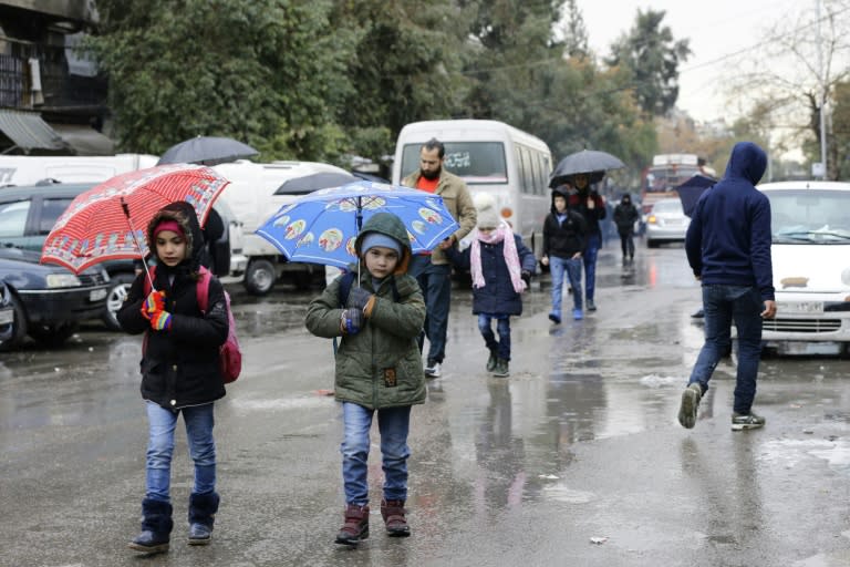 Syrian students head to school on February 18, 2018, following days of calm in Damascus's Old City, which has been bombarded by rebels entrenched on the capital's outskirts