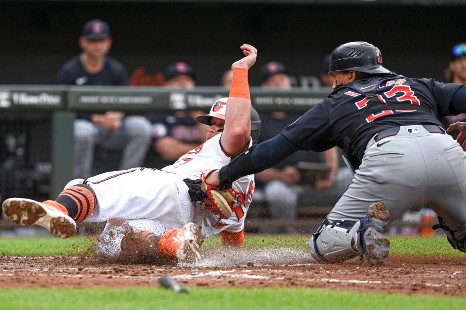 Guardians catcher Bo Naylor tags out a sliding James McCann of the Orioles in the second inning, June 25, 2024, in Baltimore.