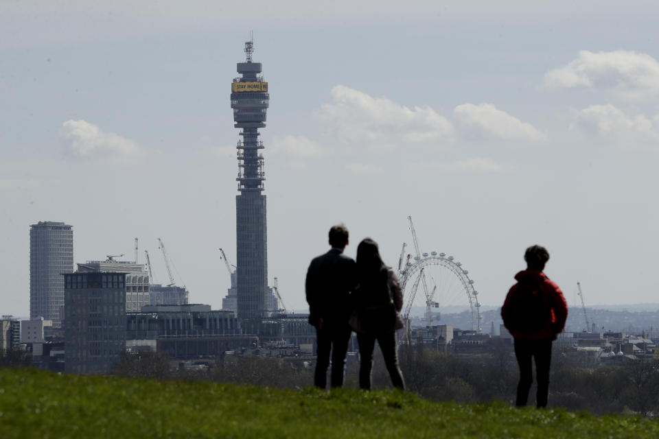 The BT Tower displays a coronavirus message requesting people stay home as seen from Primrose Hill in London, as London's parks remain open with the warning that they will close if people fail to observe the British government guidelines that include two metres social distancing from people that don't live in the same household, to help stop the spread of coronavirus, Saturday, April 4, 2020. The new coronavirus causes mild or moderate symptoms for most people, but for some, especially older adults and people with existing health problems, it can cause more severe illness or death. (AP Photo/Matt Dunham)