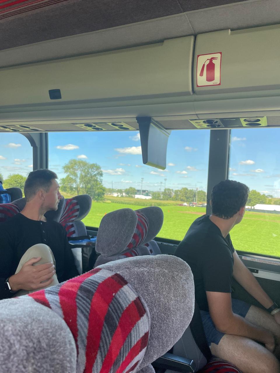 Cedar Rapids Kernels pitcher Aaron Rozek and John Stankiewicz watch as the team bus pulls up to the "Field of Dreams" movie site.