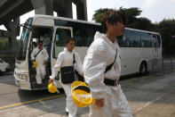 Search and rescue workers arrive at a public mortuary in Hong Kong Tuesday, Oct. 2, 2012. A boat packed with revelers on a long holiday weekend collided with a ferry and sank off Hong Kong, killing at least 36 people and injuring dozens, authorities said. The two vessels collided Monday night near Lamma Island off the southwestern coast of Hong Kong Island. (AP Photo/Kin Cheung)