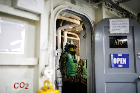 A U.S. Navy crew member stands inside U.S. aircraft carrier USS Carl Vinson during an annual joint military exercise called "Foal Eagle" between South Korea and U.S., in the East Sea, South Korea, March 14, 2017. REUTERS/Kim Hong-Ji