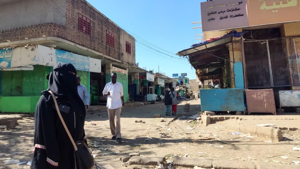 Sudanese civilians walk through a nearly empty road with many shops closed for security reasons in Gedaref city in eastern Sudan on January 10, 2024. - AFP/Getty Images
