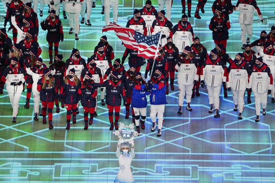 CORRECTS TO BRITTANY BOWE AND NOT ELANA MEYERS TAYLOR AS ORIGINALLY SENT -Brittany Bowe and John Shuster, of the United States, lead their team in during the opening ceremony of the 2022 Winter Olympics, Friday, Feb. 4, 2022, in Beijing. (AP Photo/Ashley Landis)