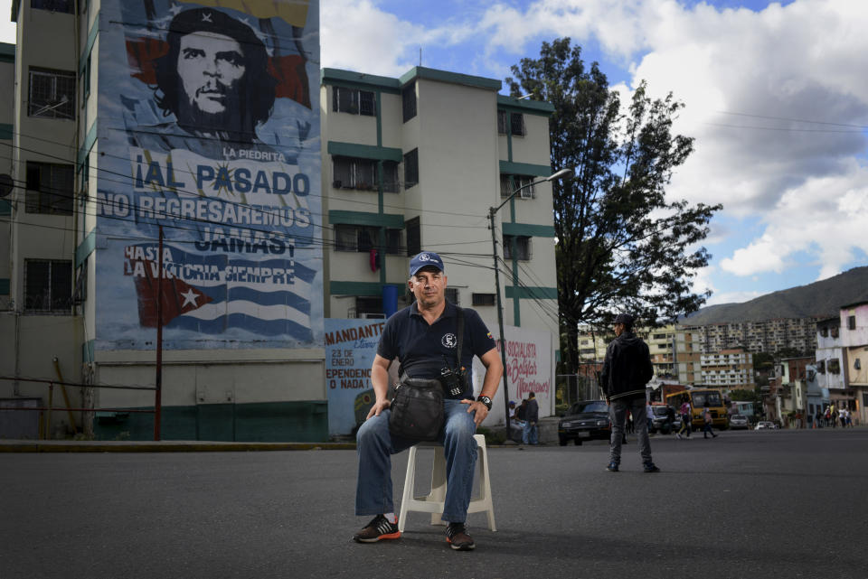 David Romero, a 46-year-old militant with the ruling United Socialist Party of Venezuela who founded the pro-government "Colectivo Salvador Allende” organization, poses for a portrait in the 23 de Enero neighborhood of Caracas, Venezuela, Thursday, Jan. 16, 2020. In spite of the complexity of Venezuela's crisis, which has hit relentlessly at the largely poor areas that is the ruling party's base of support, Romero expressed confidence that President Nicolas Maduro will be able to resolve the difficult situation and defeat Guaidó in this year's congressional elections. “I'm going to stay and struggle here, give my life if necessary for the homeland and the revolution," said Romero, who also works as a security guard at the Libertador Experimental Pedagogical University (UPEL) a state school for the formation of teachers. (AP Photo/Matias Delacroix)