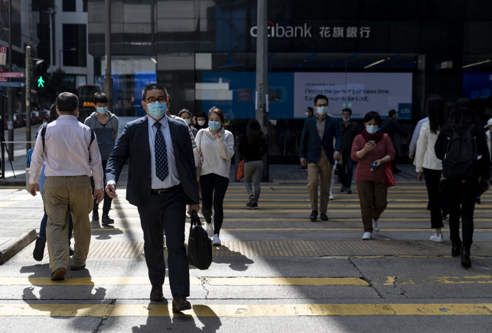  A business man wearing a face mask crosses the road in central, a heart of business and financial district. Stock markets are falling around the world after sudden escalate coronavirus cases in South Korea and Italy in the last few days. Total at least 79,300 confirmed coronavirus-related cases globally and more than 2,620 deaths worldwide. (Photo by May James / SOPA images/Sipa USA) 