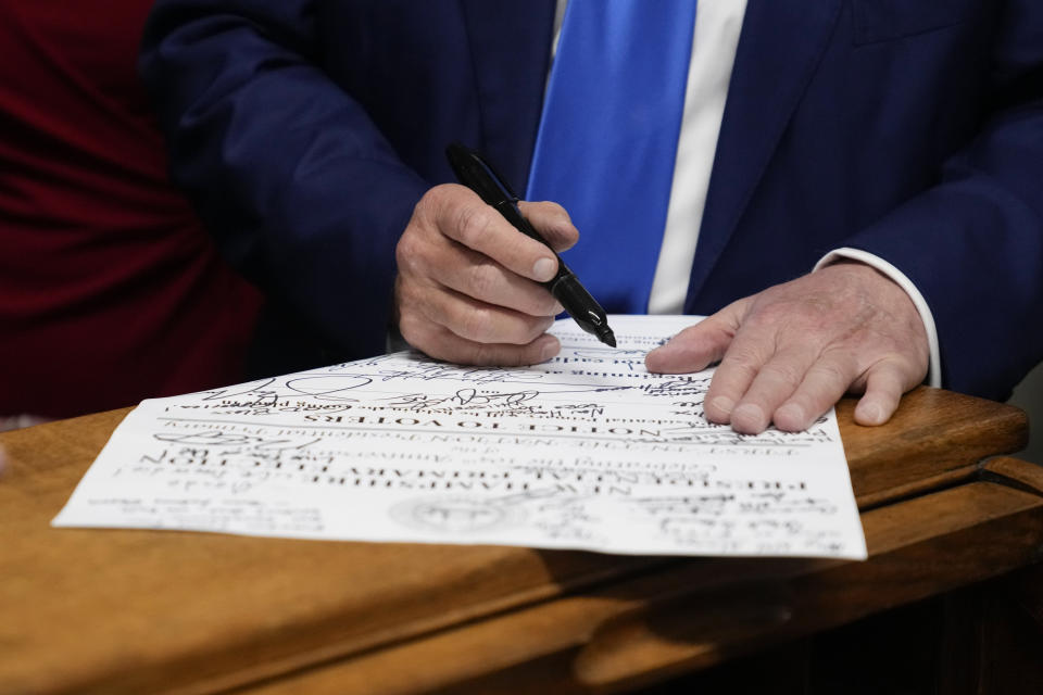 Republican presidential candidate former President Donald Trump signs a message tooters after signing papers to be on the 2024 Republican presidential primary ballot at the New Hampshire Statehouse, Monday, Oct. 23, 2023, in Concord, N.H. (AP Photo/Charles Krupa)