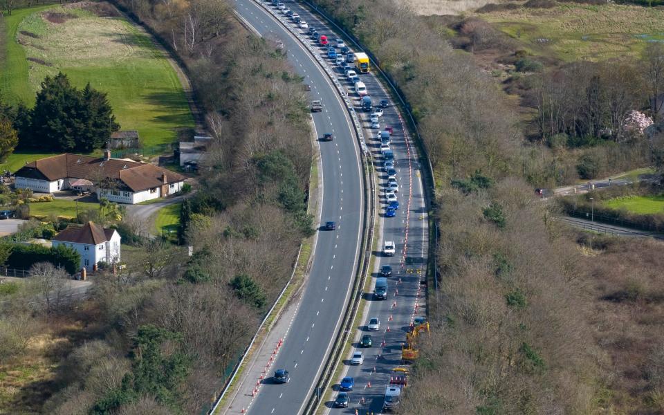 Traffic builds up on the A320 St Peter's Way crossing the M25 at Junction 11 near Addlestone