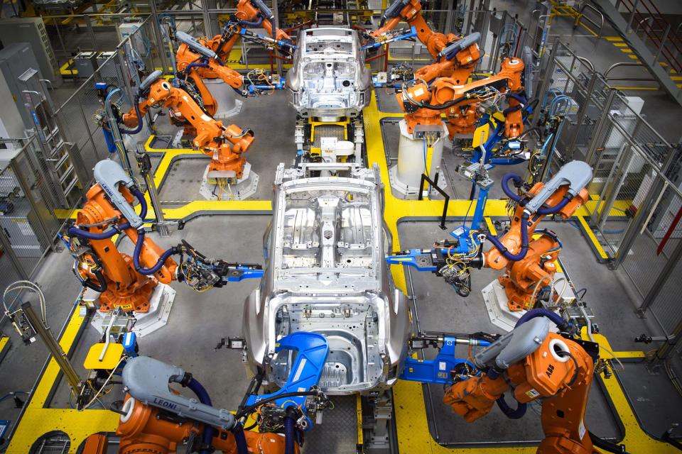 Robotic arms rivet car panels together in the Aluminium Body Shop, part of Jaguar Land Rover's Advanced Manufacturing Facility in Solihull, Birmingham. Picture date: Wednesday March 15th, 2017. Photo credit should read: Matt Crossick/ EMPICS. Aluminium Body Shop 3 is Europe's largest aluminium body shop, and contains nearly 800 robots building Jaguar F-Pace and Range Rover Velar cars. It is capable of producing an aluminium car body every 76 seconds. 