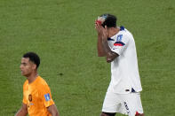 Weston McKennie of the United States reacts next to Cody Gakpo of the Netherlands, left, during the World Cup round of 16 soccer match between the Netherlands and the United States, at the Khalifa International Stadium in Doha, Qatar, Saturday, Dec. 3, 2022. (AP Photo/Luca Bruno)