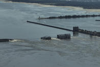 CAPTION CORRECTS LOCATION - Water flows over the collapsed Kakhovka Dam in Nova Kakhovka, in Russian-occupied Ukraine, Wednesday, June 7, 2023. (AP Photo)