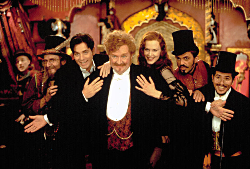 ewan mcgregor, nicole kidman, jim boradbent, and other cast members posing and smiling after performing a dance number