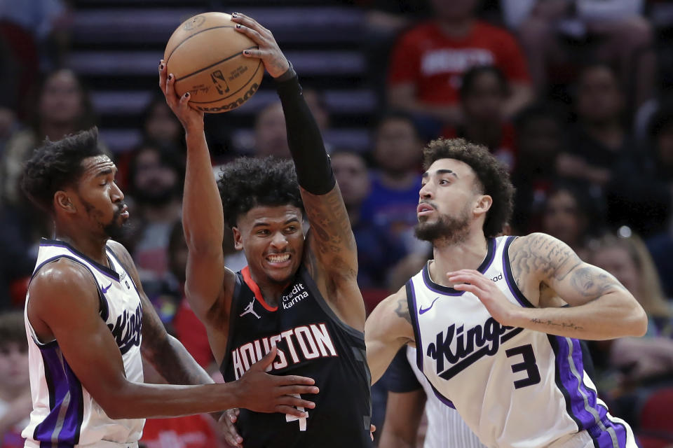 Houston Rockets guard Jalen Green, center, attempts to drive between Sacramento Kings guards Malik Monk, left, and Chris Duarte (3) during the first half of an NBA basketball game Saturday, Nov. 4, 2023, in Houston. (AP Photo/Michael Wyke)