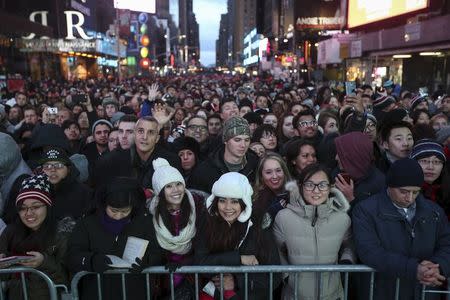 People stand in a penned of area of Times Square during New Year's Eve celebrations in Manhattan December 31, 2015. REUTERS/Carlo Allegri