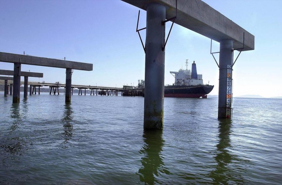 The oil tanker Overseas Chicago is framed by a pier under construction in 2000 at Cherry Point in Whatcom County. The U.S. Army Corps of Engineers Monday, Jan. 23, limited the handling of crude oil at BP Cherry Point Marine Terminal to 191 million barrels a year and prevents BP from using the terminal unless authorized by the corps.