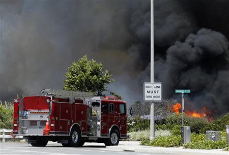 Firefighters arrive to battle wildfires in Carlsbad, California May 14, 2014. REUTERS/Mike Blake