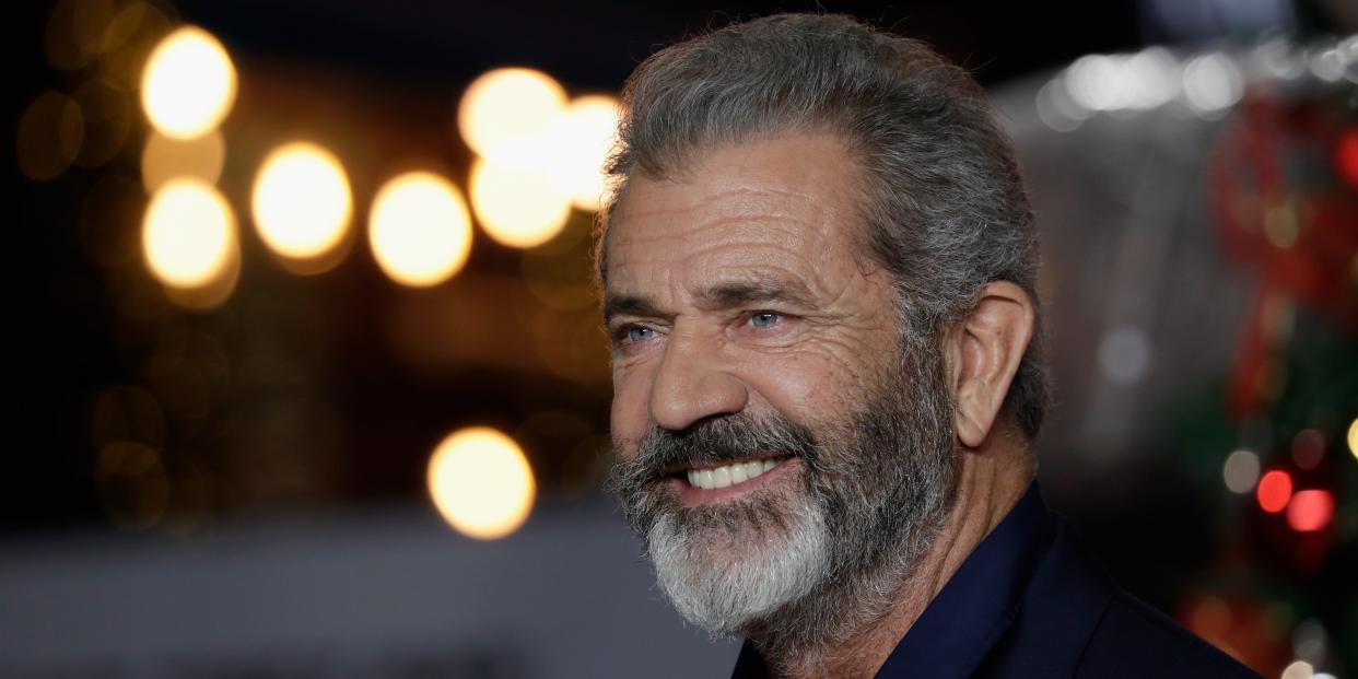 Mel Gibson smiles on a red carpet.