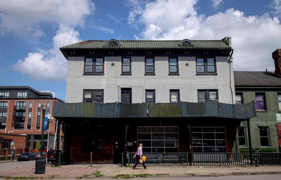 A man walks by the building that was the site of Two Keys Tavern for 66 years in Lexington, Ky., Monday, August 3, 2020. The tavern filed for bankruptcy in July due to coronavirus-related closures and loss of revenue.