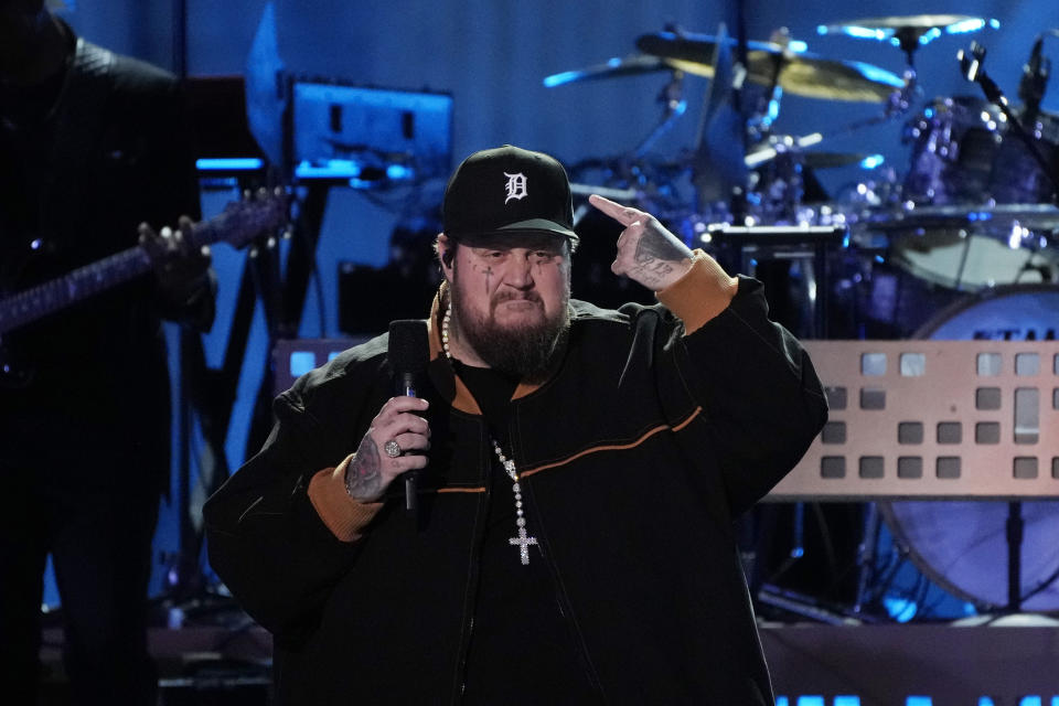 Jelly Roll points to his Detroit cap during a performance at "Live From Detroit: The Concert at Michigan Central" on Thursday, June 6, 2024, in Detroit. (AP Photo/Carlos Osorio)