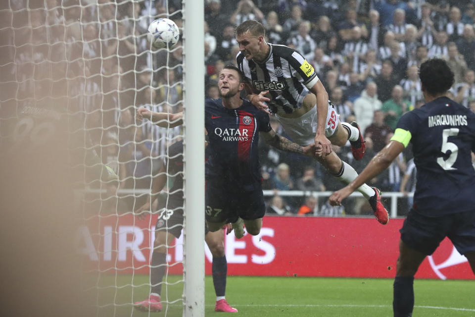 Newcastle's Dan Burn scores a goal during the Champions League group F soccer match between Newcastle and Paris Saint Germain at St. James' Park, Wednesday, Oct. 4, 2023, in Newcastle, England. (AP Photo/Scott Heppell)