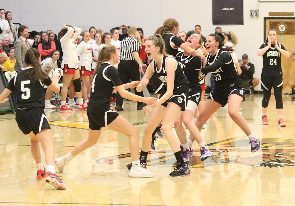 St. Johnsbury celebrates after beating Rutland in overtime during Monday's Division I high school girls basketball semifinals at UVM's Patrick Gym.