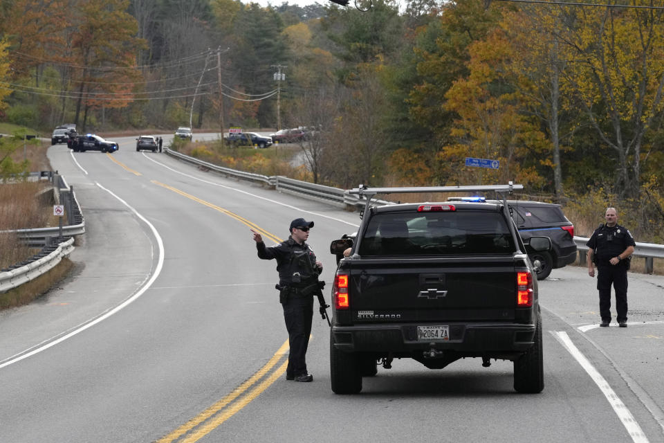 FILE - Police officers speak with a motorist at a roadblock, Thursday, Oct. 26, 2023, in Lisbon, Maine, as they search Robert Card, the suspect in a deadly mass shootings. Thousands of pages Maine State Police documents released Friday, June 7, 2023, include detailed descriptions of the chaos and carnage surrounding the state’s deadliest mass shooting. (AP Photo/Robert F. Bukaty, File)