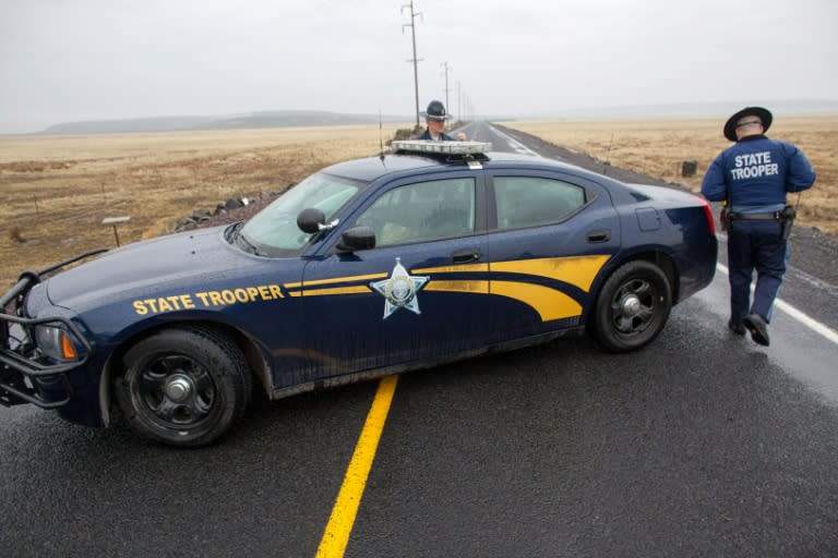 Oregon State Police monitor a checkpoint on Highway 78 approximately 4 miles from the Malheur Wildlife Refuge Headquarters near Burns, Oregon on January 28, 2016