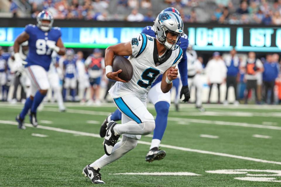 Aug 18, 2023; East Rutherford, New Jersey, USA; Carolina Panthers quarterback Bryce Young (9) scrambles in front of New York Giants linebacker Azeez Ojulari (51) during the first quarter at MetLife Stadium. 