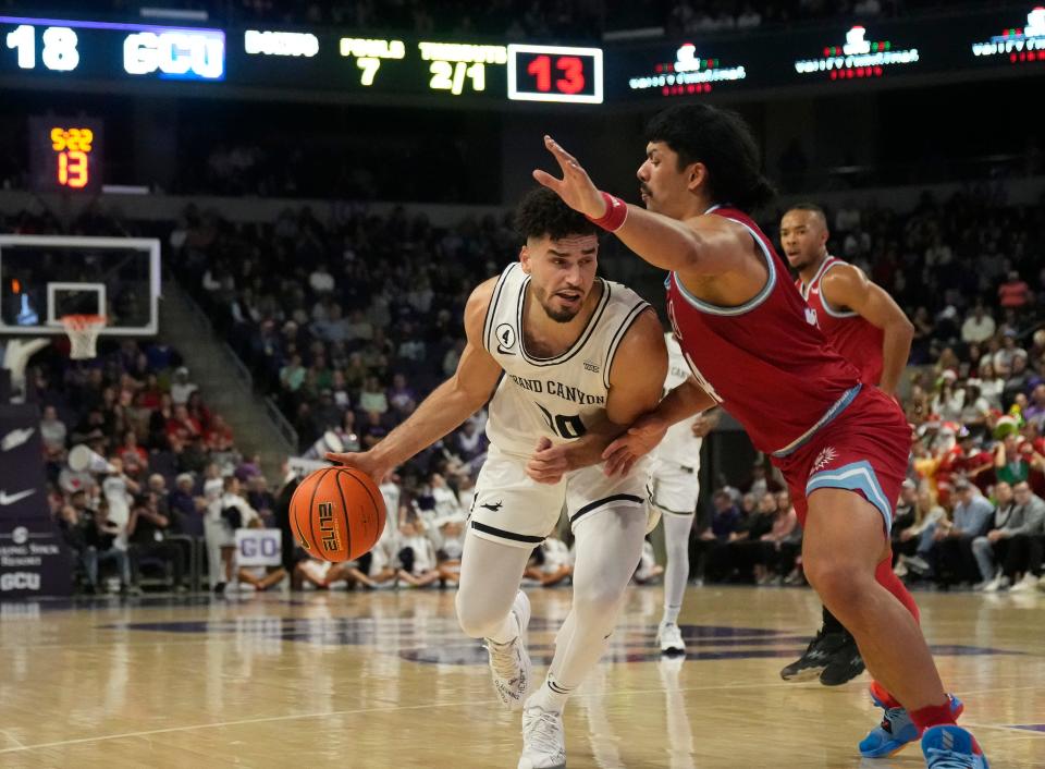 Dec 7, 2022; phoenix, Ariz., U.S.;  Grand Canyon Antelopes forward Gabe McGlothan (30) attempts to dribble around Loyola Marymount Lions forward Keli Leaupepe (34) during a menÕs basketball game at Grand Canyon University Arena. Mandatory Credit: Cheryl Evans-Arizona Republic