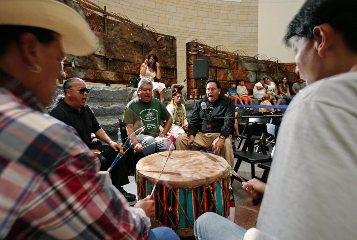 Members of the Yellow Hammer Native American drum band from Ponca City, Oklahoma, play a song for Native American dancers inside the newly opened National Museum of the American Indian in Washington, DC in 2005: Getty