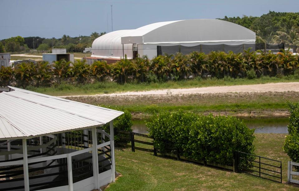 View of a building, right, that a neighbor in the Palm Beach Point community in Welllington claims is full of manure.