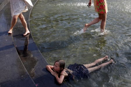 A girl plays in the fountain at Washington Square Park in Manhattan