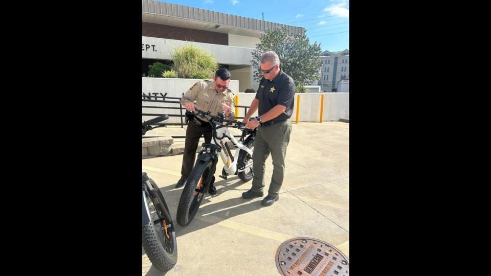 Captain G. Cale Becker and Sheriff Jeff Connor inspect one of the donated bicycles.