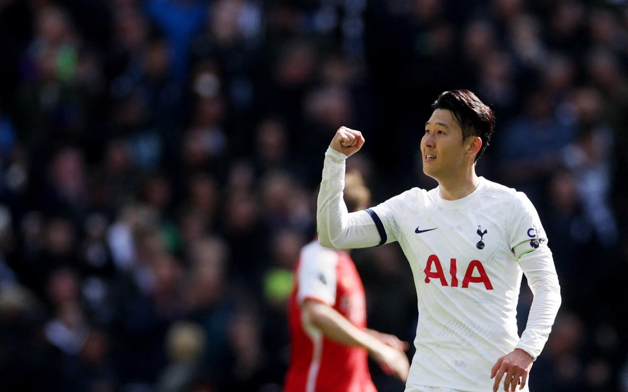 Son celebrates scoring his penalty