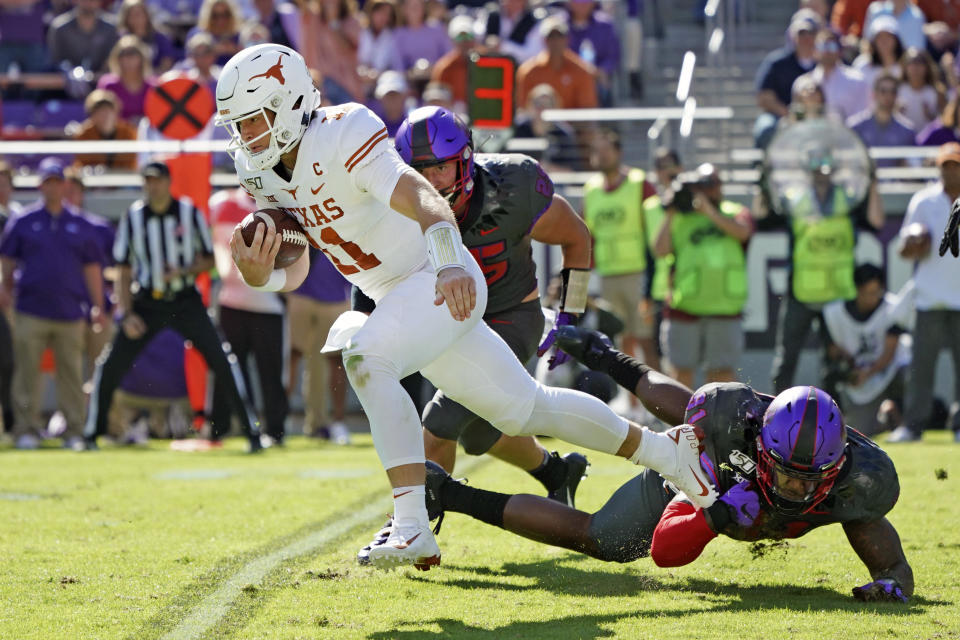 Texas quarterback Sam Ehlinger (11) breaks away on a run in the first half of an NCAA college football game against TCU in Fort Worth, Texas, Saturday, Oct. 26, 2019. (AP Photo/Louis DeLuca)