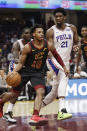 Cleveland Cavaliers' Darius Garland (10) drives past Philadelphia 76ers' Joel Embiid (21) in the first half of an NBA basketball game, Wednesday, Feb. 26, 2020, in Cleveland. (AP Photo/Tony Dejak)