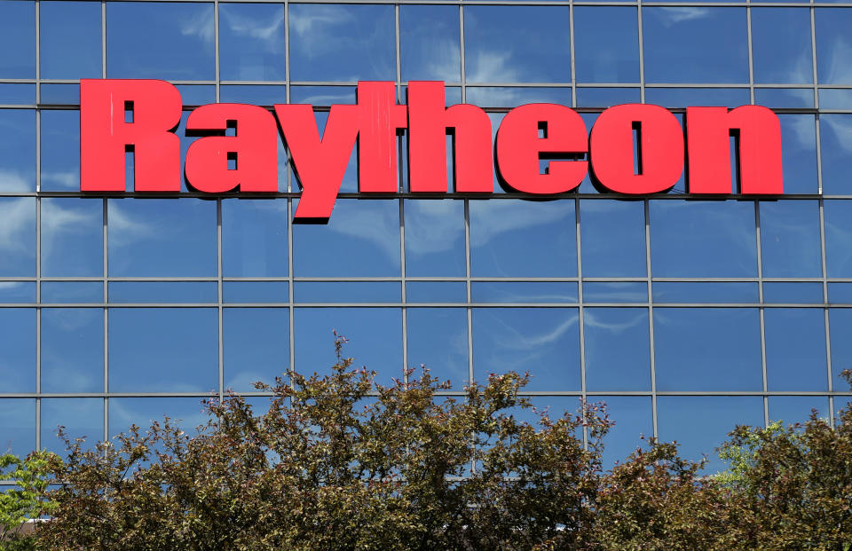 The sky is reflected on the facade of Raytheon's Integrated Defense Systems facility, Monday, June 10, 2019, in Woburn, Mass. Raytheon Co. and United Technologies Corp. are merging in a deal that creates one of the world's largest defense companies. (AP Photo/Elise Amendola)