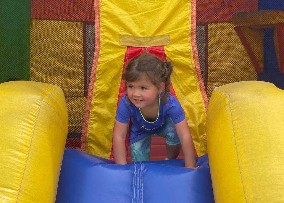 Camila Pruitt, 4, looks for mom as she plays on the inflatable castle at the fourth annual Community Bazaar at Karns High School Saturday, April 30, 2022.