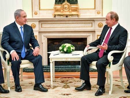 Russian President Vladimir Putin speaks with Israeli Prime Minister Benjamin Netanyahu during their meeting at the Kremlin in Moscow, Russia July 11, 2018. Yuri Kadobnov/Pool via REUTERS