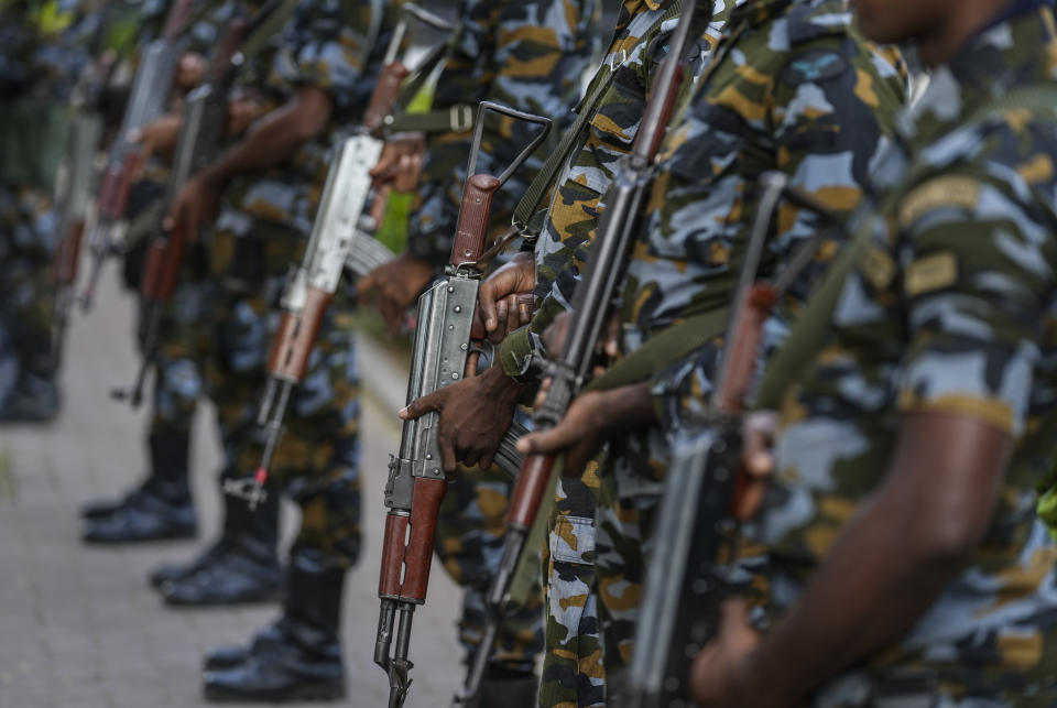 Army soldiers hold their guns as they stand guard outside prime minister Ranil Wickremesinghe's office building in Colombo, Sri Lanka, Thursday, July 14, 2022. Sri Lankan protesters retreated from government buildings they seized and military troops reinforced security at the Parliament on Thursday, establishing a tenuous calm in a country in both economic meltdown and political limbo.(AP Photo/Rafiq Maqbool)