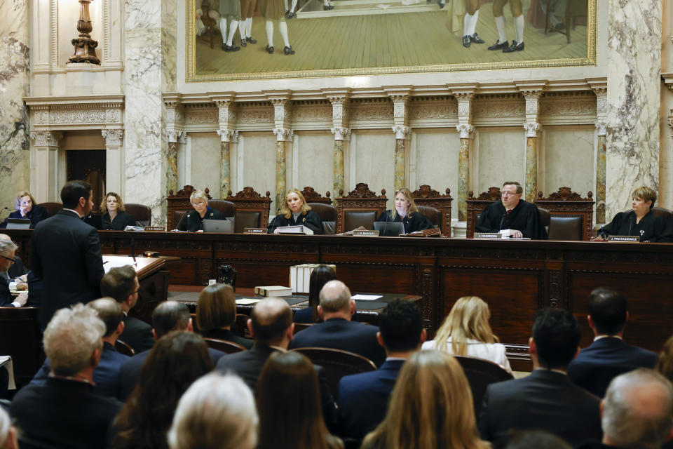 FILE - The Wisconsin Supreme Court listens to arguments from Wisconsin Assistant Attorney General Anthony D. Russomanno, representing Gov. Tony Evers, during a redistricting hearing at the state Capitol, Nov. 21, 2023, in Madison, Wis. The Wisconsin Supreme Court decided Monday, July 1, 2024, to consider two challenges to a 175-year-old law that conservatives maintain bans abortion without letting the cases wind through lower courts. (Ruthie Hauge/The Capital Times via AP, Pool, File)