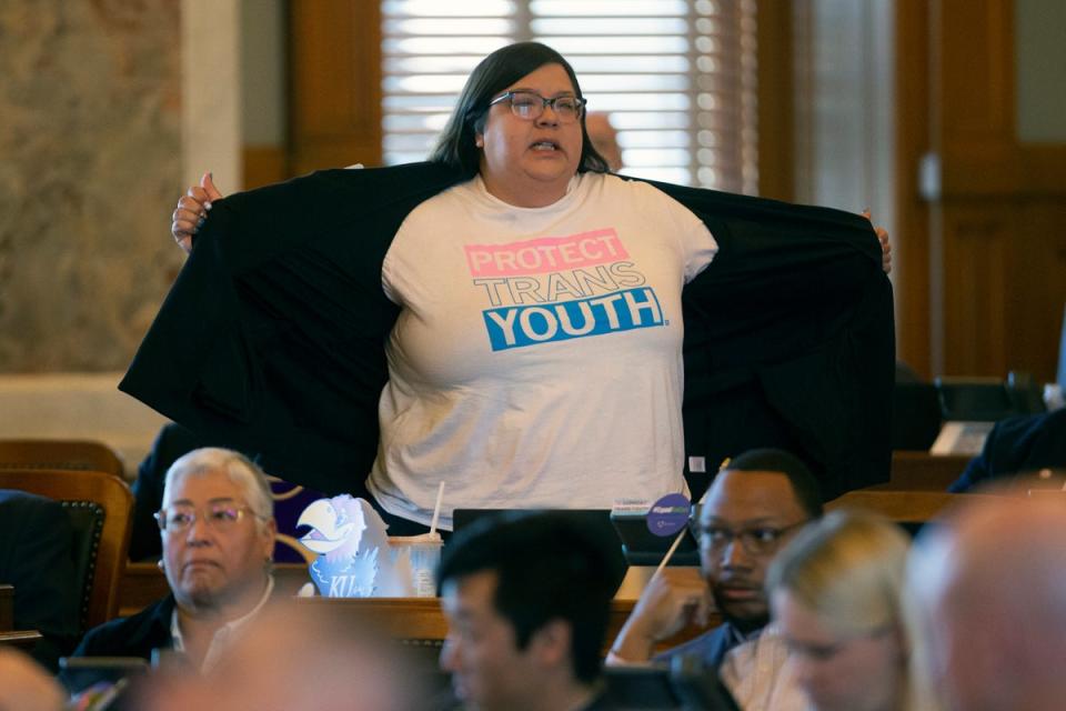 Kansas state Rep Heather Meyer protested a vote to override the governor’s veto of a bill banning trans women and girls from competing in school sports on 5 April. (AP)