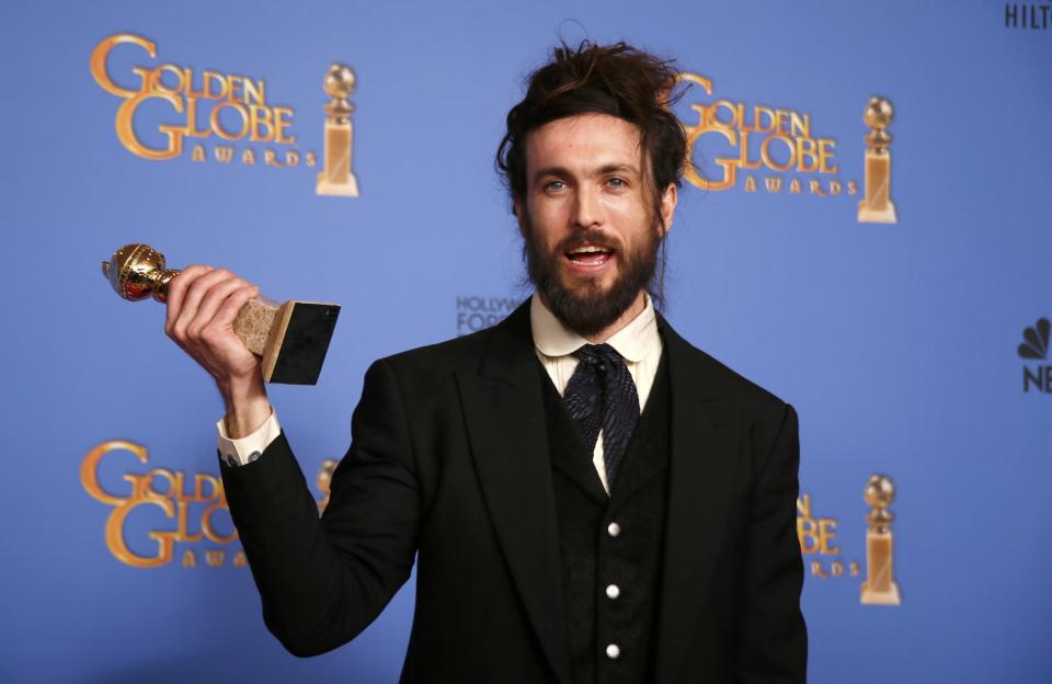 Alex Ebert poses backstage with his award for Best Original Score - Motion Picture for the film "All is Lost" at the 71st annual Golden Globe Awards in Beverly Hills